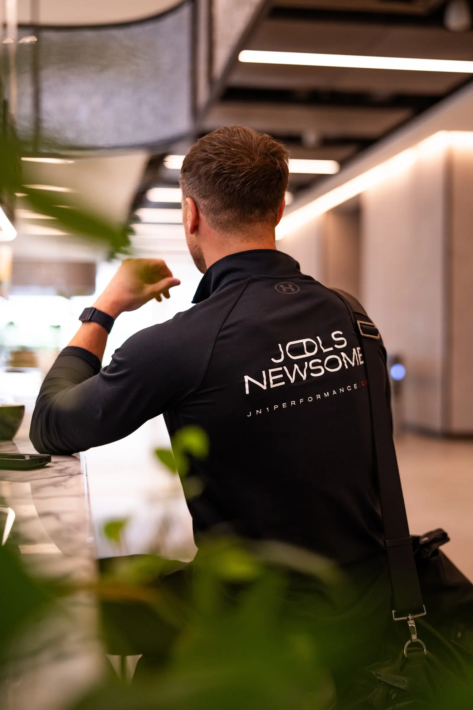 Jools Newsome at UNTIL, his wordmark and switch device on the back of his training top.